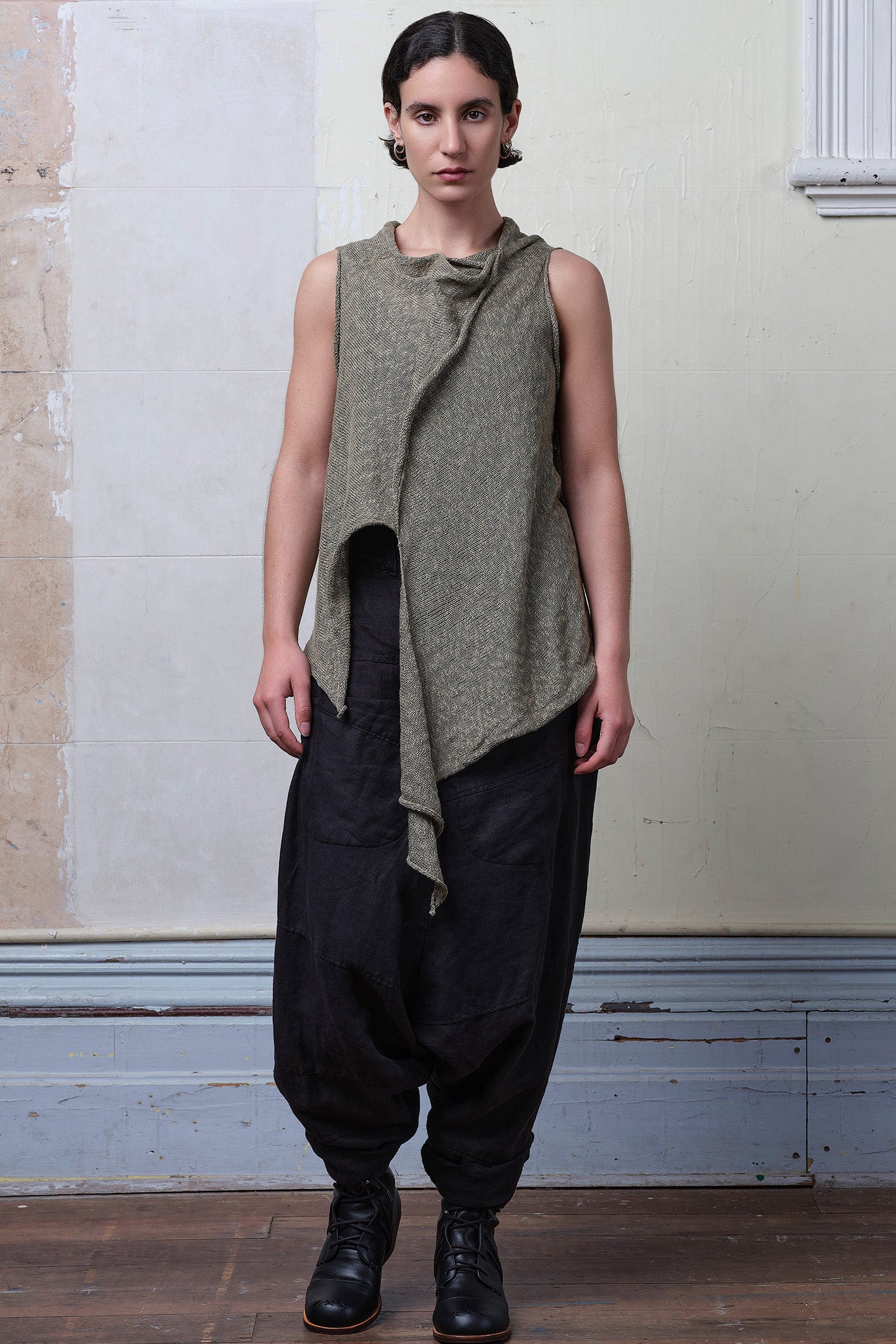 Model wears textured cotton/linen self curling vest in lichen colourway. Designed and knitted in Melbourne, by Wendy Voon knits.