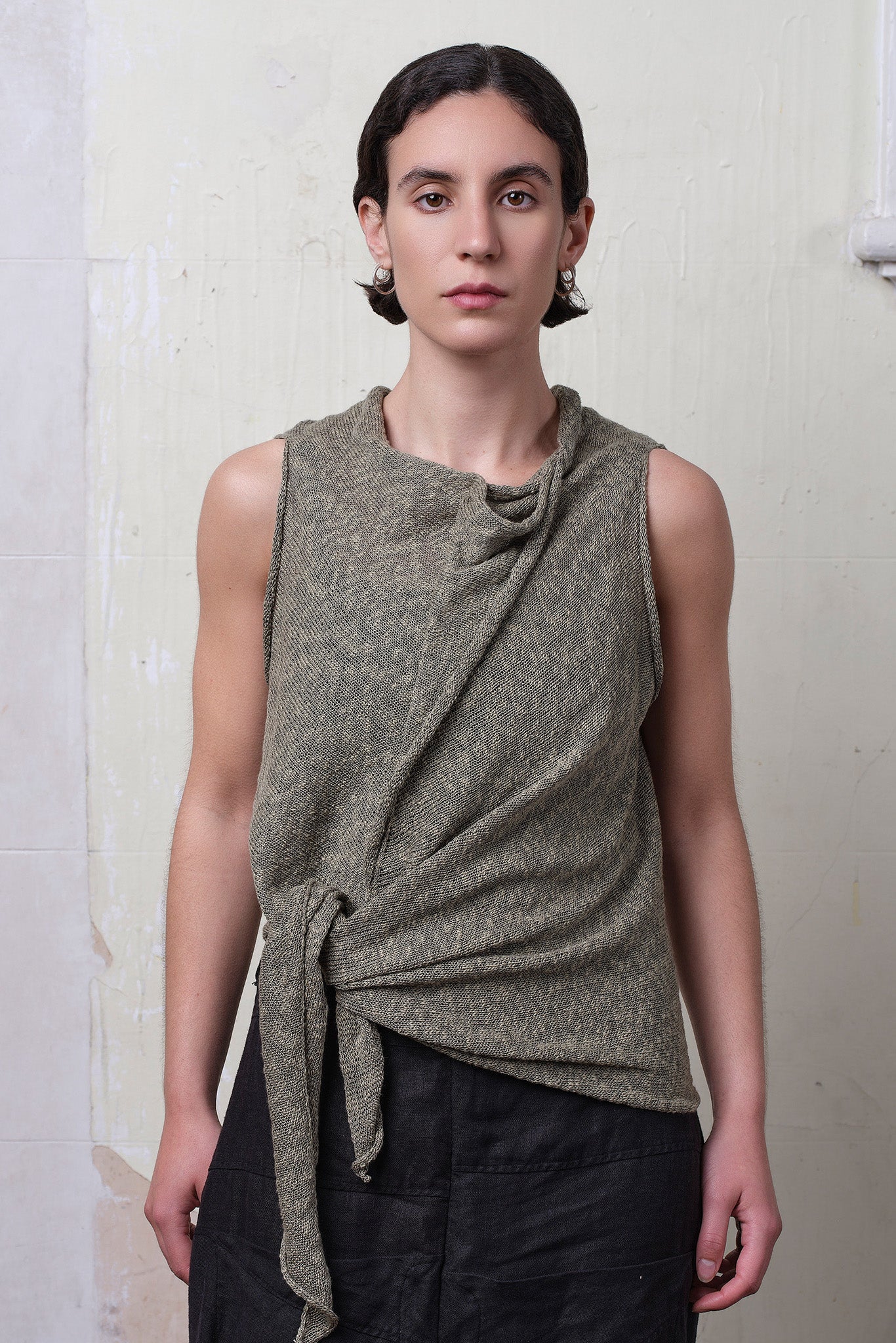 Model wears textured cotton/linen self curling vest in lichen colourway. Designed and knitted in Melbourne, by Wendy Voon knits.