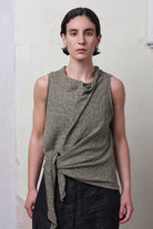 Model wears textured cotton/linen self curling vest in lichen colourway. Designed and knitted in Melbourne, by Wendy Voon knits.