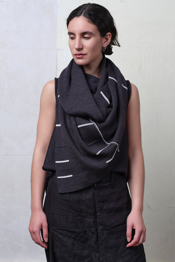 Model wears superfine merino linework scarf featuring off white stripe detail on charcoal. Designed and knitted in Melbourne by Wendy Voon knits