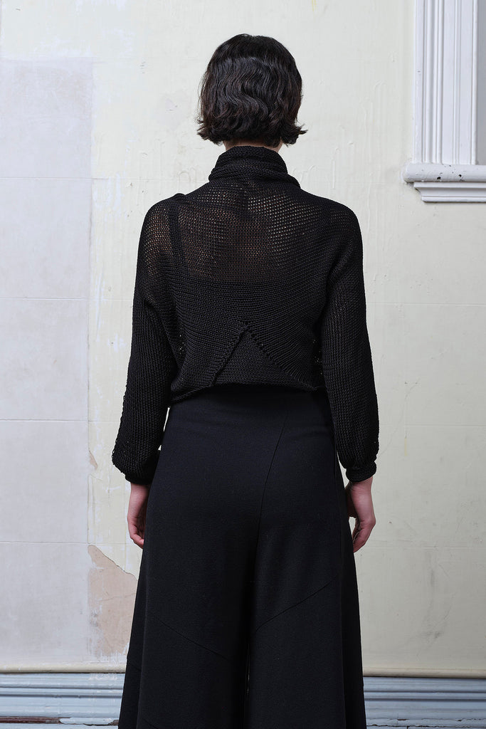 Back view of model wearing black cotton cropped jumper, designed and knitted in Melbourne by Wendy Voon knits