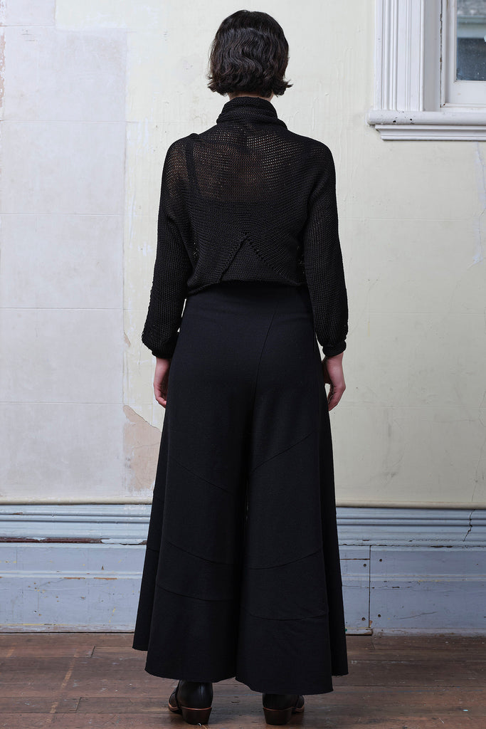 Back view of model wearing black cotton cropped jumper upside down, designed and knitted in Melbourne by Wendy Voon knits