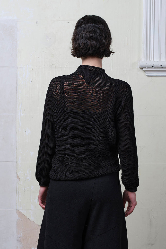 Back view of model wearing black cotton cropped jumper upside down. Designed and knitted in Melbourne by Wendy Voon knits