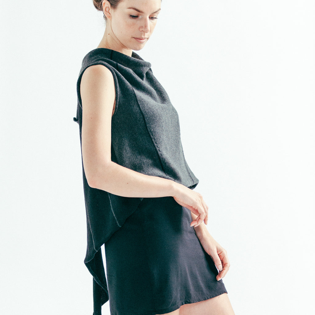 Side front view of Two Toned Self Curling vest in charcoal and black, worn back to front showing stripe detail and asymmetric hem