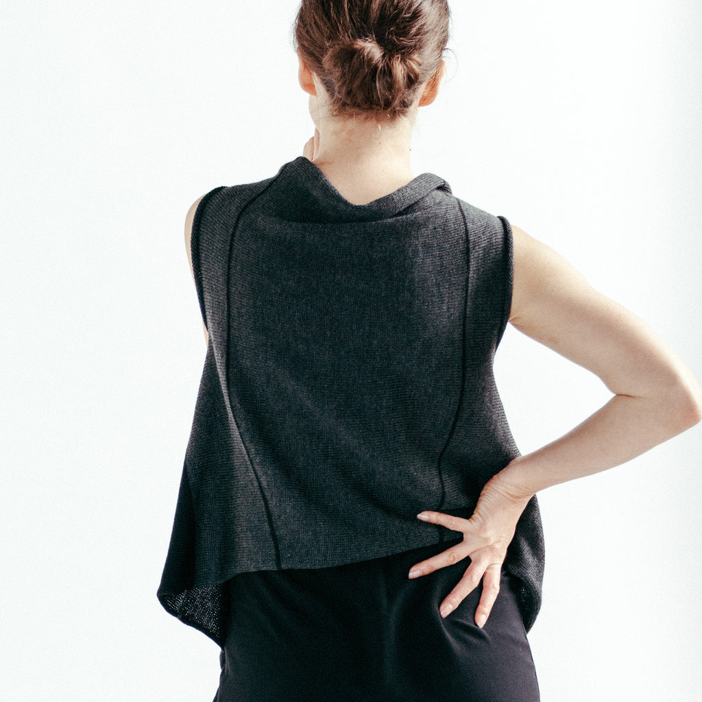 Back view of Two Toned Self Curling vest design by Wendy Voon knits in charcoal and black merino wool