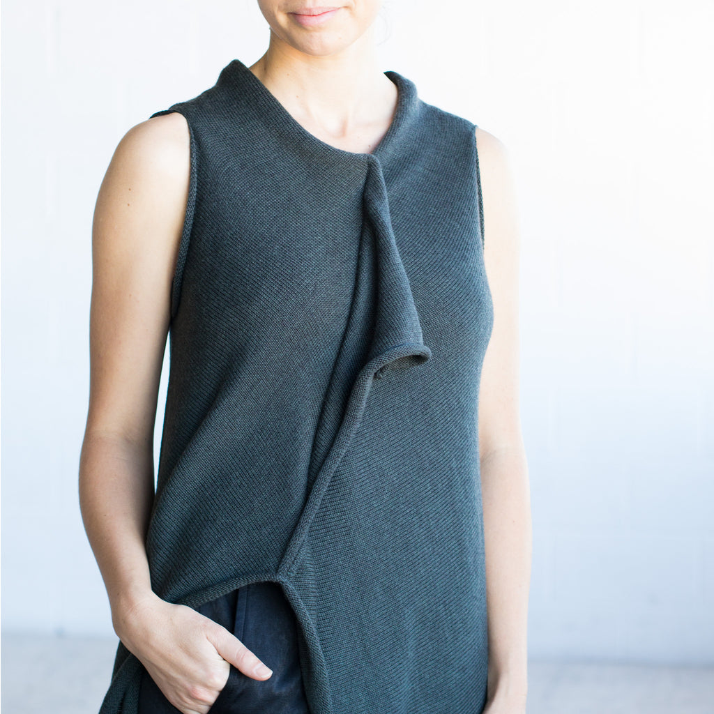Front detail view of Asymmetric Longline vest design by Wendy Voon knits in deep forest green merino wool