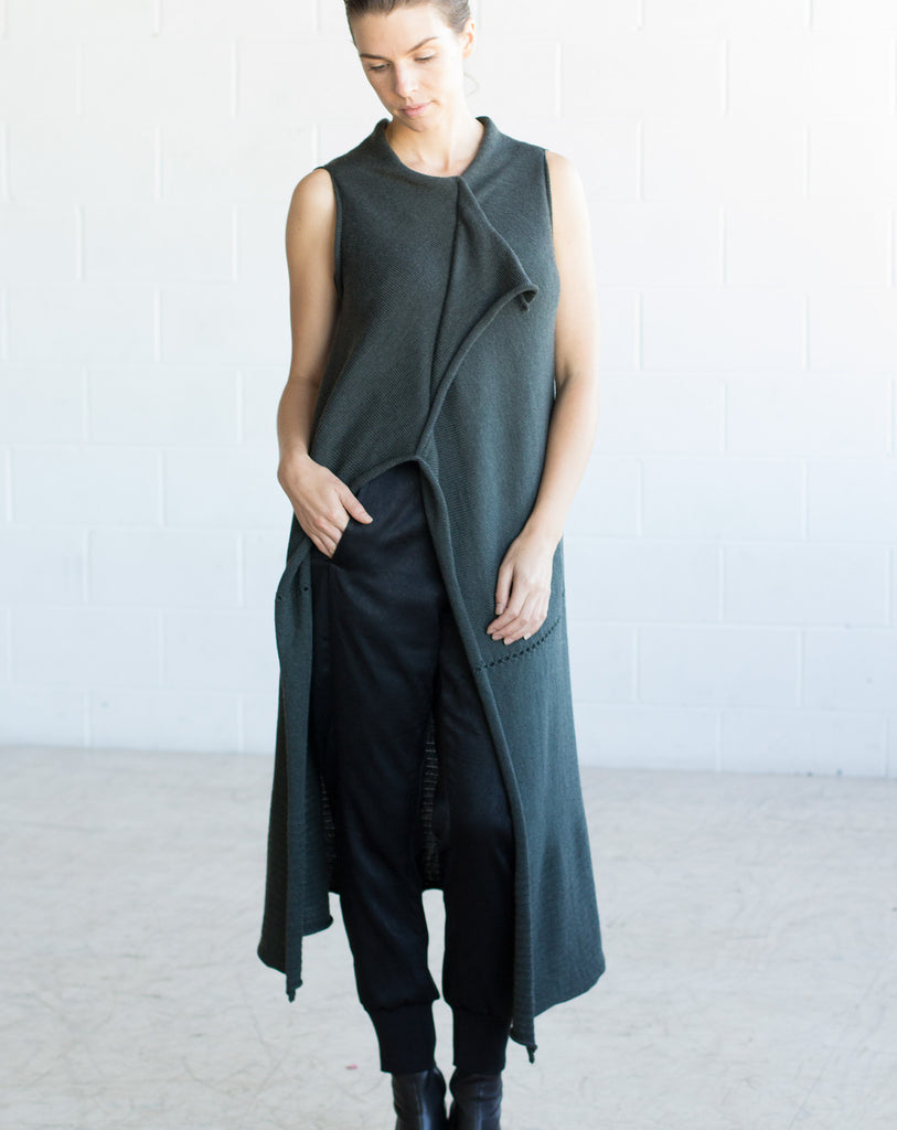 Front full length view of Asymmetric Longline vest design by Wendy Voon knits in deep forest green merino wool