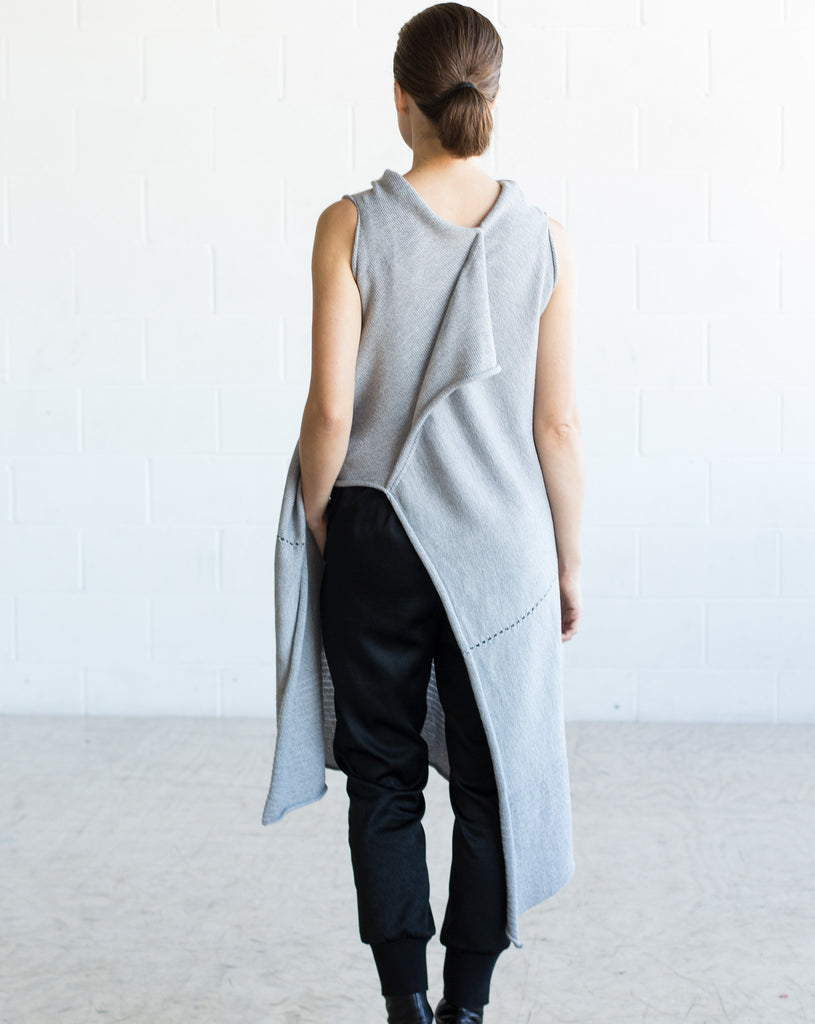 Back view of Asymmetric Longline vest design in silver grey melange merino, worn back to front with seam and stitch detail