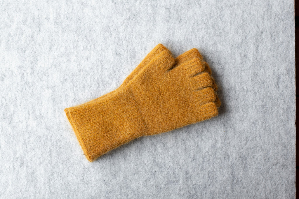 Pumpkin coloured fingerless gloves, knitted in an angora and lambswool blend