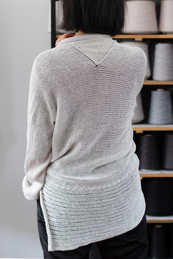 Back view of pearl coloured cotton back scoop jumper, worn upside down, designed and knitted by Wendy Voon knits.