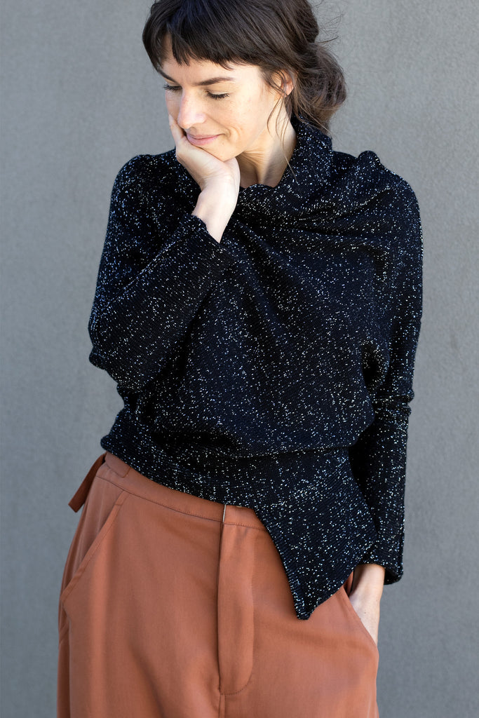 Front view of Bias jumper, a design by Wendy Voon knits in a sparkly black  merino wool and lurex blend fabric. 