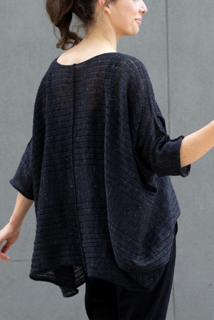 Back view of tulip shaped top in charcoal flecked linen and merino wool blend, designed by Wendy Voon.