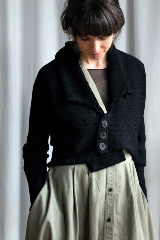 Front view of Chunky Knit Cardigan design by Wendy Voon in black merino wool with black buttons worn closed