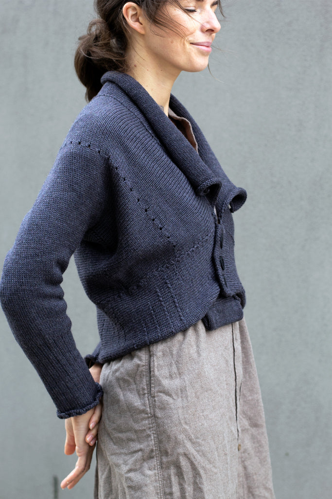 Side view of Chunky Knit Cardigan design by Wendy Voon in charcoal merino wool with black buttons worn closed