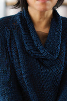 Close up fabric view of deep ocean coloured open knit cotton jumper with funnel neck, designed and knitted by Wendy Voon.