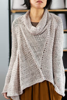 Front view of dusty coloured open knit cotton jumper with funnel neck, designed and knitted by Wendy Voon