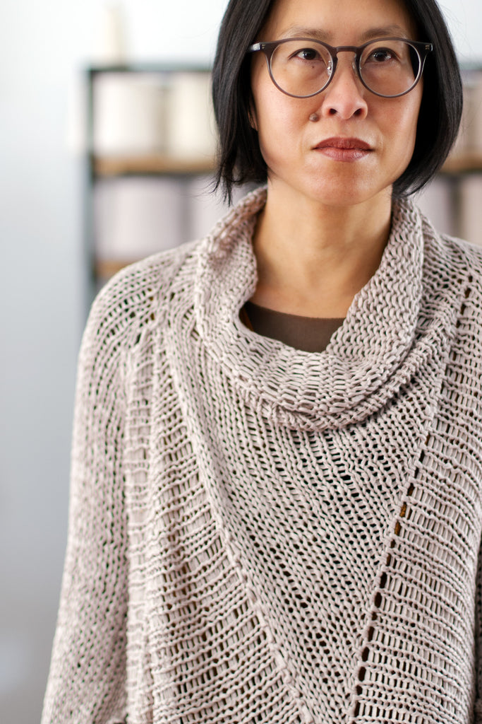 Fabric view of dusty coloured open knit cotton jumper with funnel neck, designed and knitted by Wendy Voon