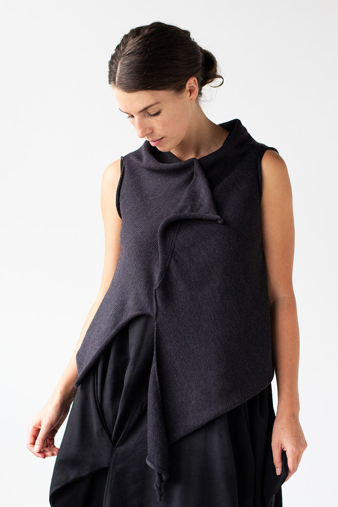 Front view of Asymmetric Self Curling Vest design by Wendy Voon knits in charcoal merino wool