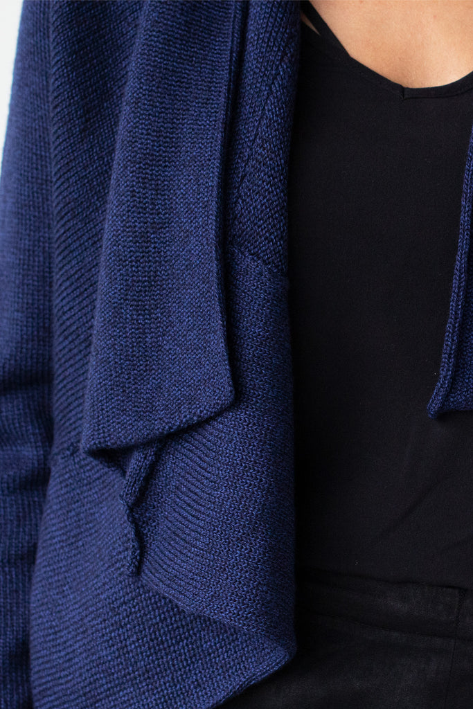 Front detail of Shawl Collared Cardigan collar drape and seam detail in blue melange merino wool, worn short bolero style