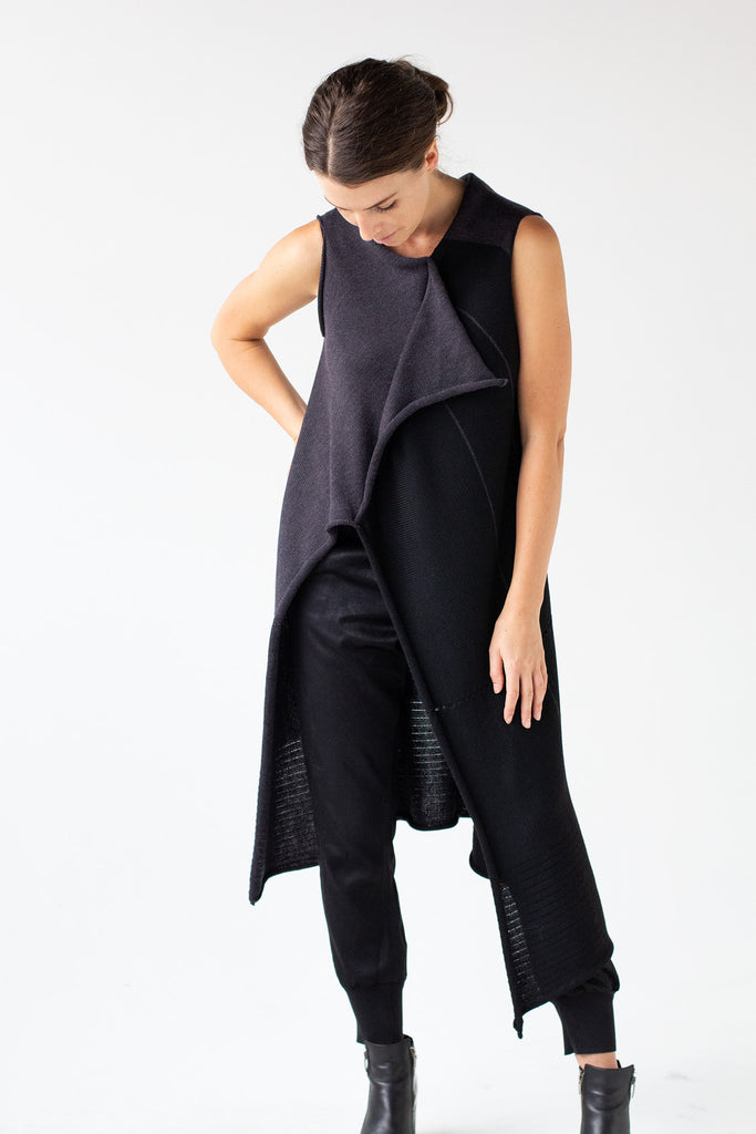 Front full length view of Two Toned Asymmetric Longline vest design by Wendy Voon knits in charcoal and black merino wool