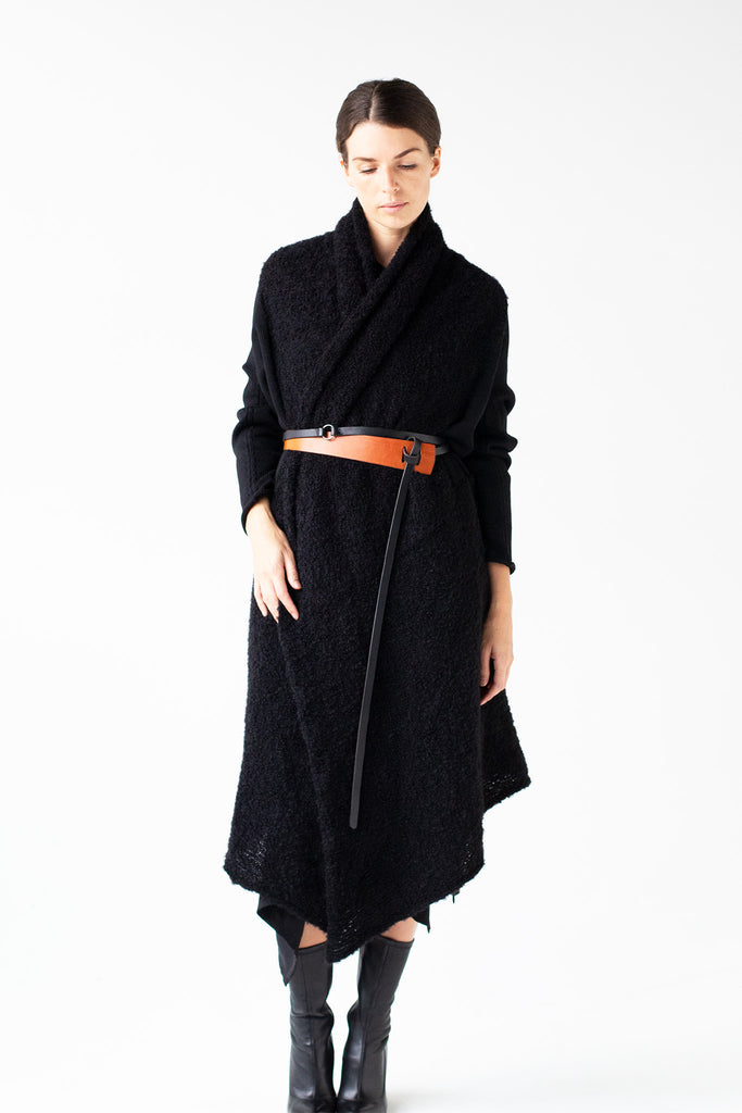 Full length front view of Logical Progression Coat by Wendy Voon in black merino and alpaca wool, worn long and belted at waist