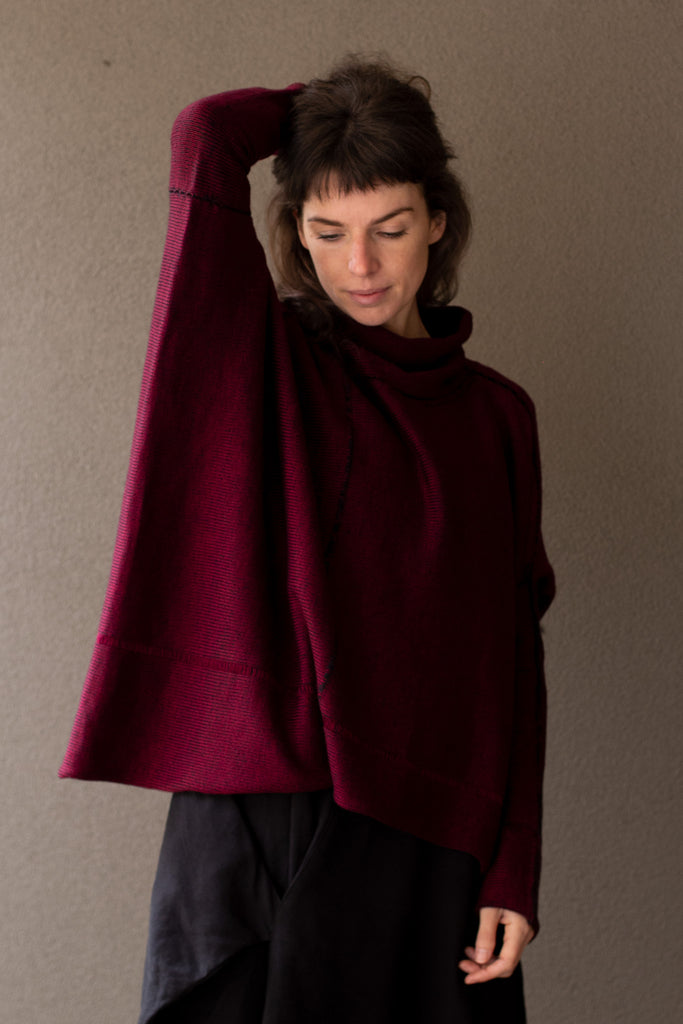 Front view of box shaped jumper designed by Wendy Voon, in a burgundy with black backed fabric, made from superfine merino wool.