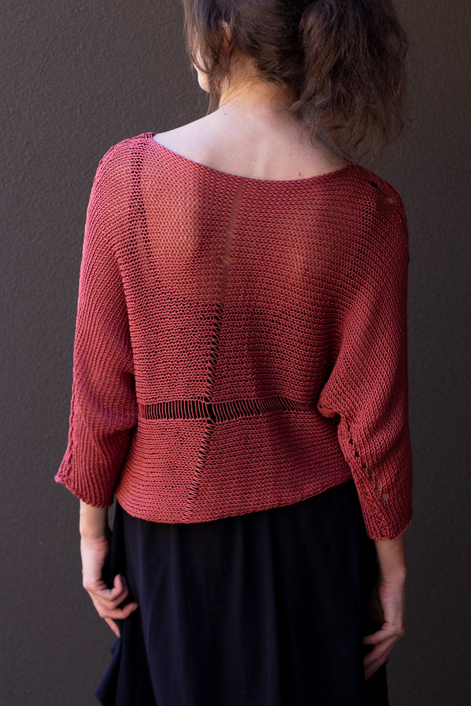 Back view of Cotton Batwing  in coral colourway, featuring large stitch details,  designed by Wendy Voon knits.