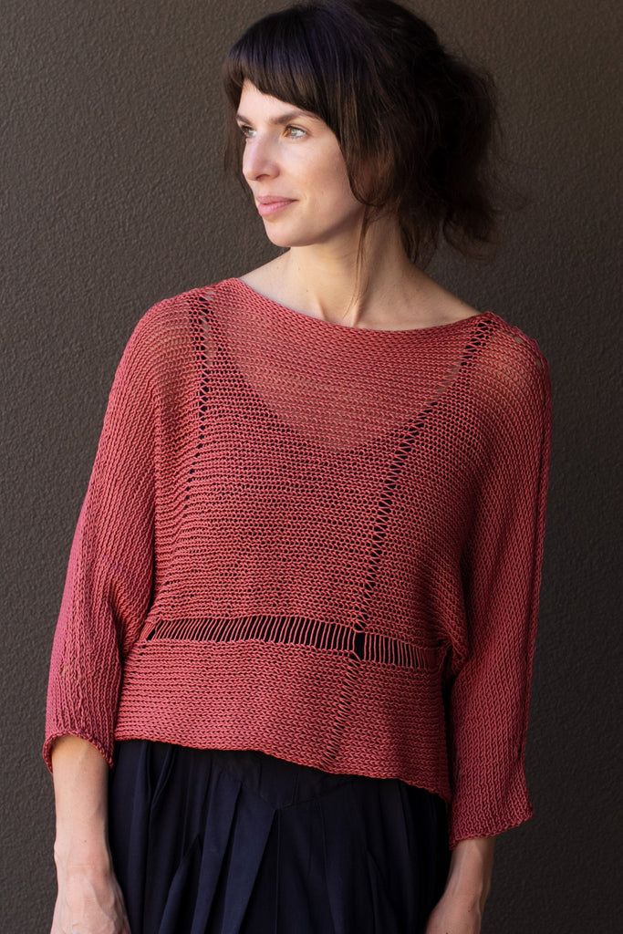 Front view of Cotton Batwing  in coral colourway, featuring large stitch details,  designed by Wendy Voon knits.