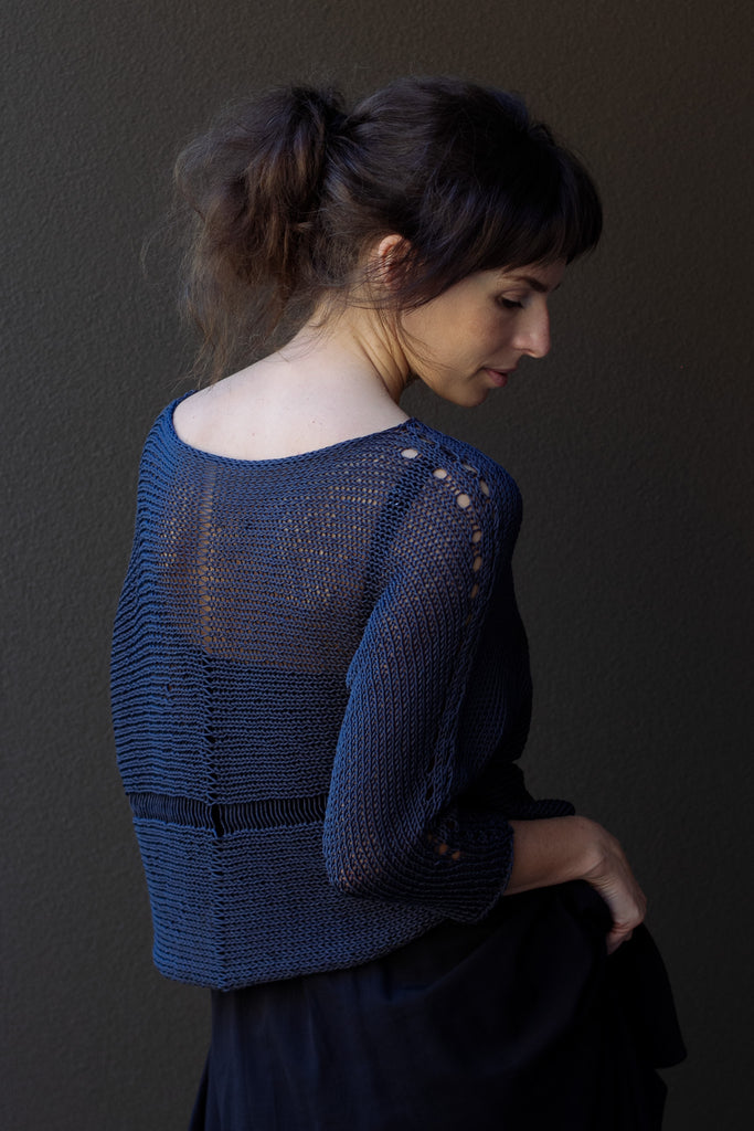 Back view of Cotton Batwing  in slate colourway, featuring lace details along garment seam,  designed by Wendy Voon knits.