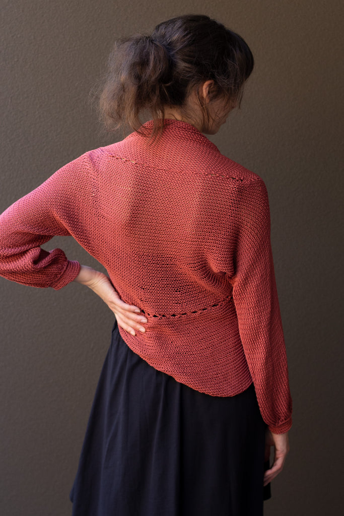 Back view of model wearing coral cotton cowl neck jumper, designed  and knitted in Melbourne by Wendy Voon knits