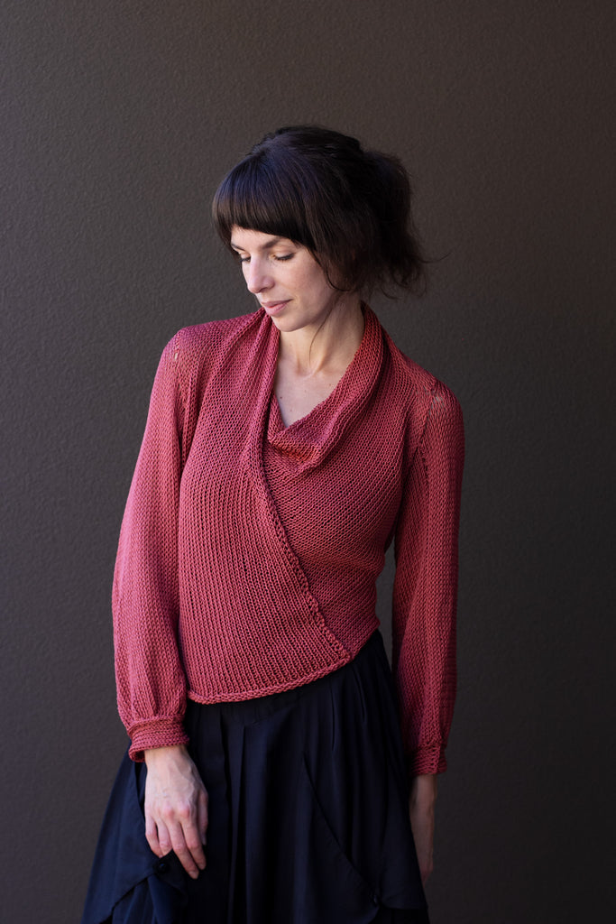Front profile of model wearing coral cotton cowl neck jumper, designed  and knitted in Melbourne by Wendy Voon knits