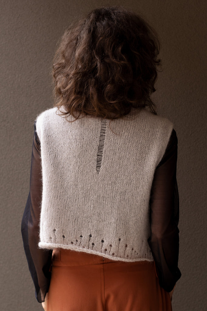 Back view of super soft knitted vest in a dust of pink colourway, featuring laddered laceholes, made from baby alpaca, mohair and silk. Designed and made in Melbourne by Wendy Voon knits