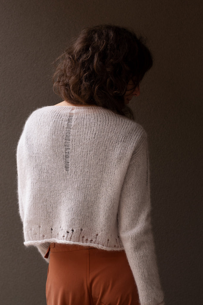 Back view of super soft knitted jumper in a dust of pink colourway, featuring laddered laceholes, made from baby alpaca, mohair and silk. Designed and made in Melbourne by Wendy Voon knits