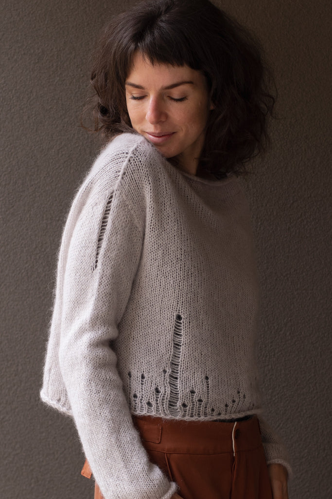 Side view of super soft knitted jumper in a dust of pink colourway, featuring laddered laceholes, made from baby alpaca, mohair and silk. Designed and made in Melbourne by Wendy Voon knits