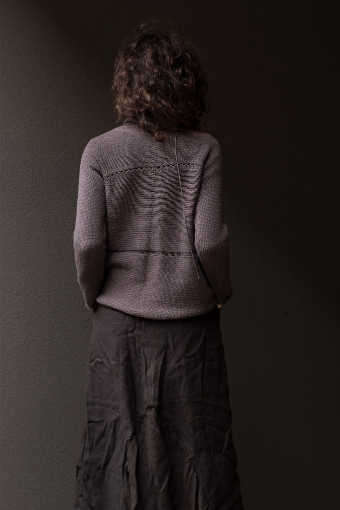 Back view of taupe superfine merino wool/polyamide jumper, designed by Wendy Voon knits, made in Melbourne.  Jumper features triangular panels at front with loose threads left as design feature