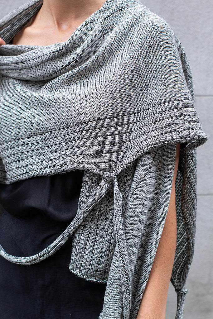 Front detail view of Multi-Wrap in Linen by Wendy Voon in silver linen with black reverse, worn as cropped shawl style wrap