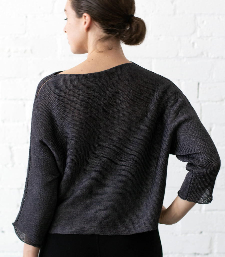Back view of Linen Batwing jumper design by Wendy Voon knits in charred eggplant linen, showing batwing silhouette