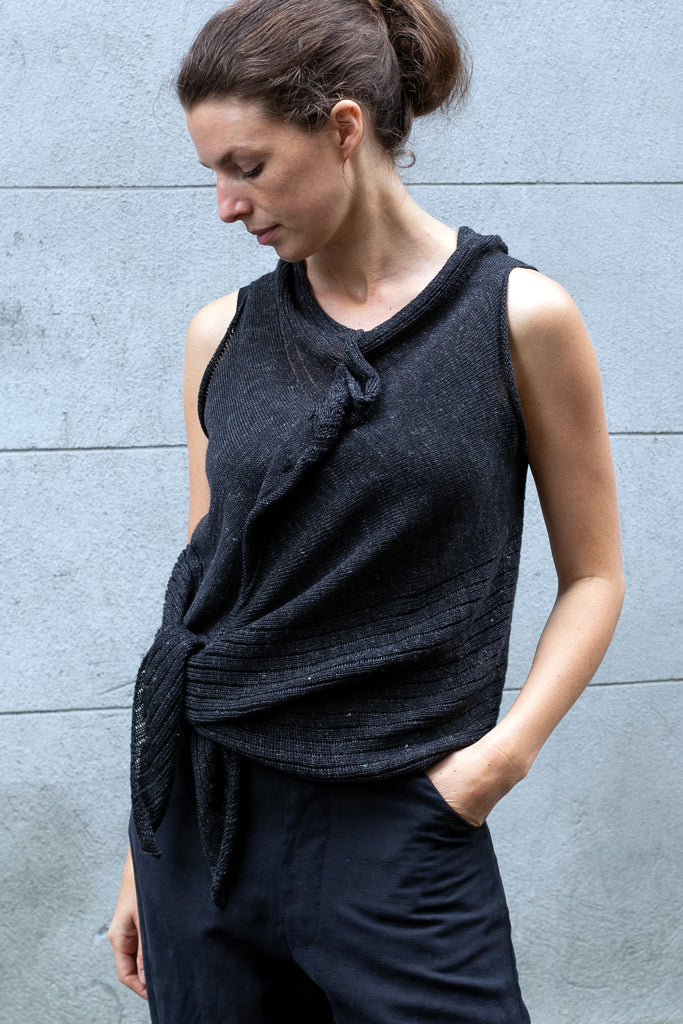 Front view of Linen Laddered Vest tied at waist design by Wendy Voon knits in charcoal flecked linen, showing laddered fabric design detail