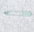 Giant safety pin in duck egg