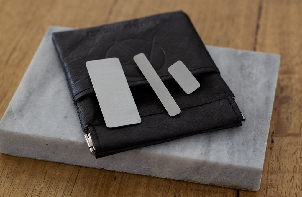 A set of three rectangular brooches of different sizes made from reclaimed stainless steel.