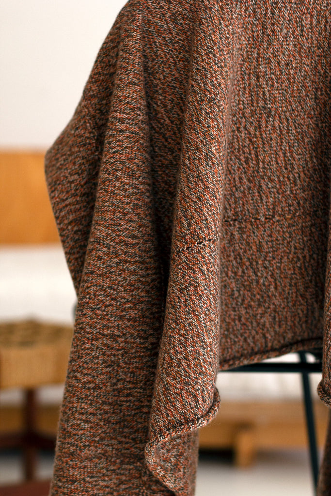 Close up fabric view of knitted wool cropped jacket in rust, army and cream melange, designed by Wendy Voon, knitted in Melbourne.