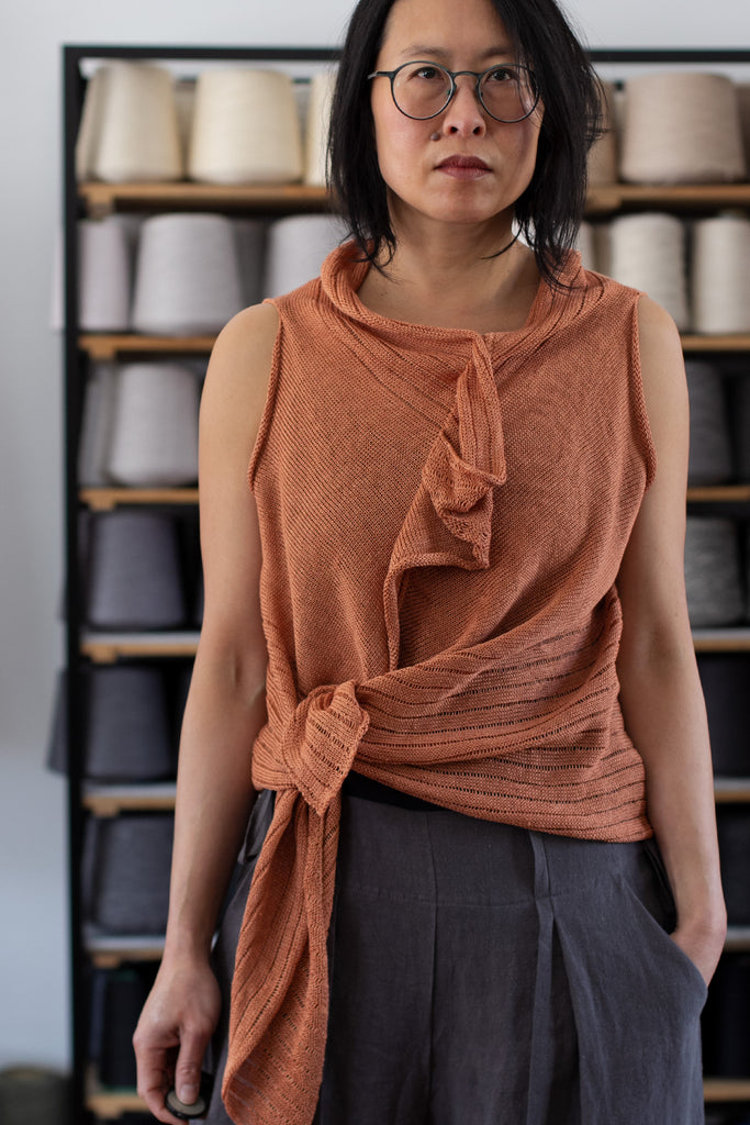 Front view of Linen Laddered Vest knotted, design by Wendy Voon knits in linen, showing laddered fabric design detail, in sienna colourway