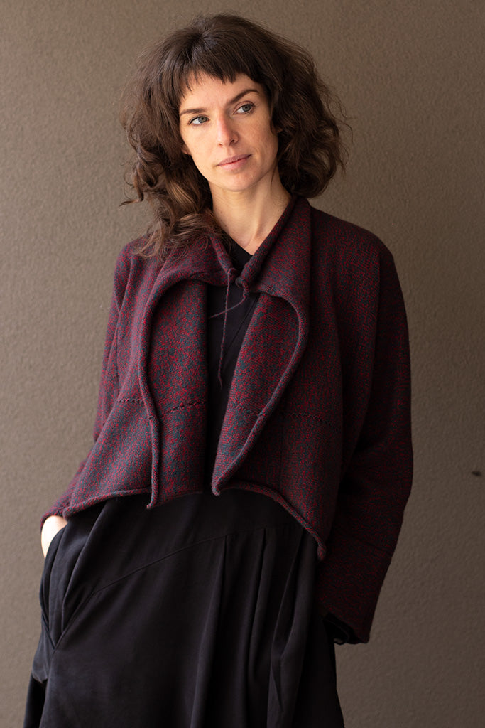Front view of knitted wool cropped jacket in red and teal melange, designed by Wendy Voon, knitted in Melbourne.