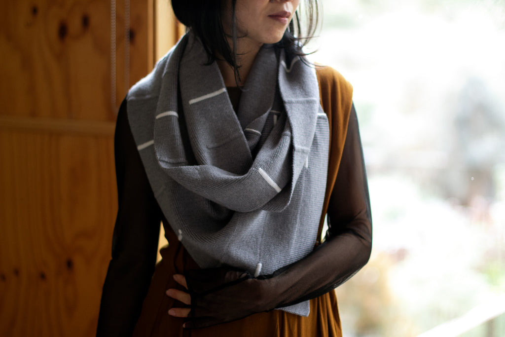 Front view of Linework Scarf design by Wendy Voon in grey merino with white stripes, worn double looped infinity style