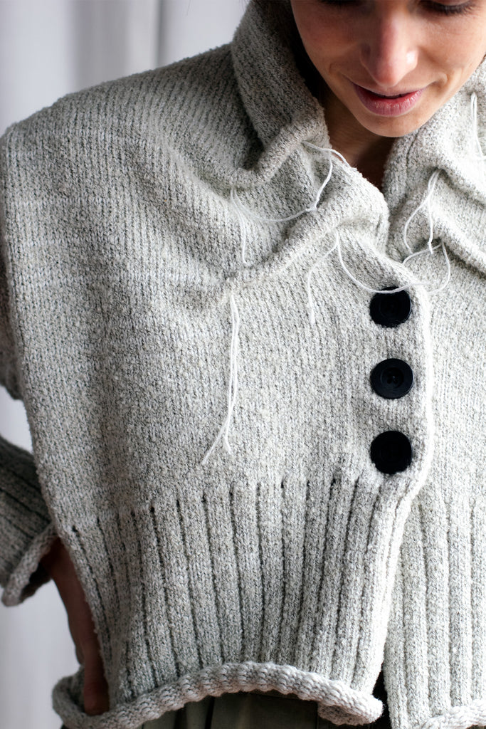 Close up fabric view of off white superfine merino wool cardi, with ruched detail around the neck, designed and made by Wendy Voon knits.