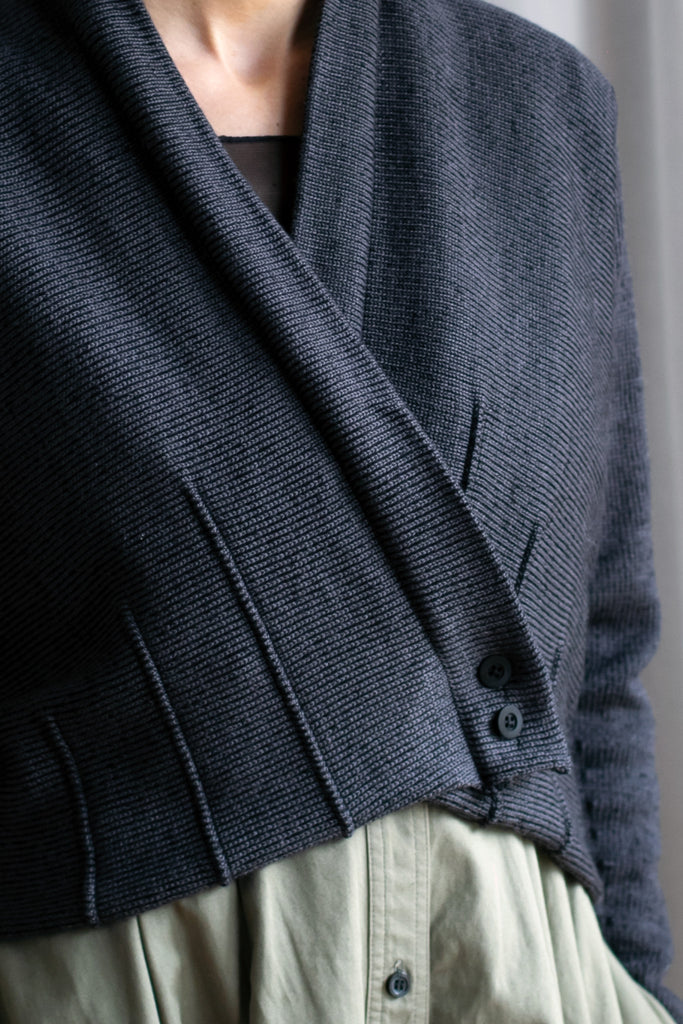 Front close up view of welted wool cardigan buttoned up in slate/black colourway