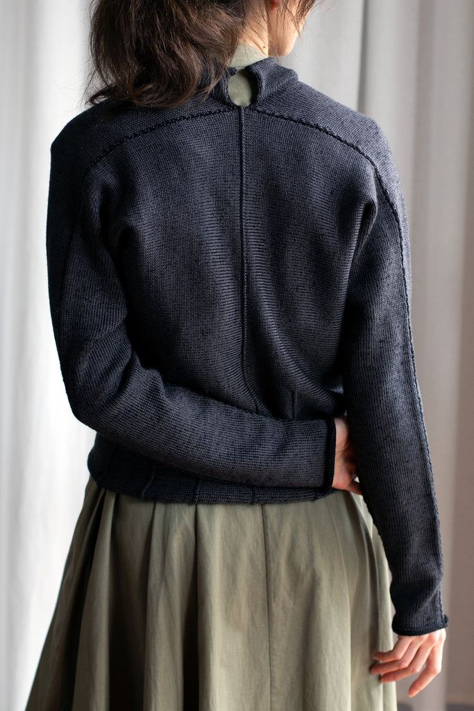 Back view of welted wool cardigan  in slate/black colourway