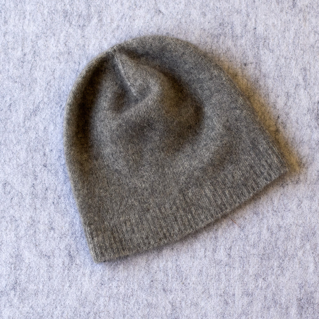 Light grey coloured knitted beanie made from merino wool, possum and silk