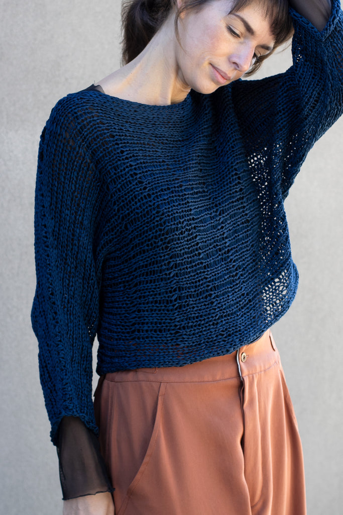 Close up view  of Large Stitch Batwing jumper, knitted  in Ocean coloured cotton ribbon yarn, designed by Wendy Voon