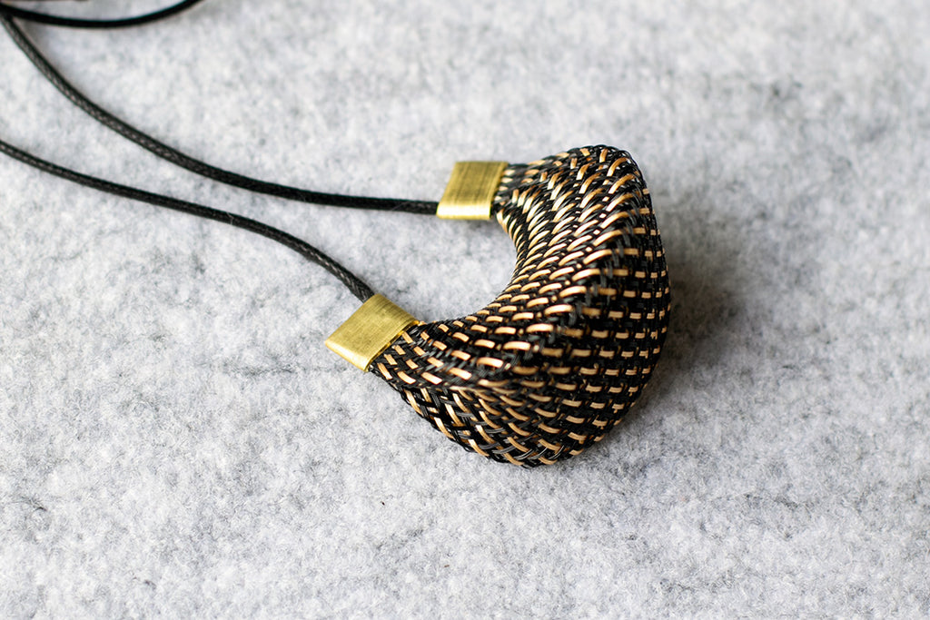 Strand necklace in entwined bronze mesh necklace with brass hardware